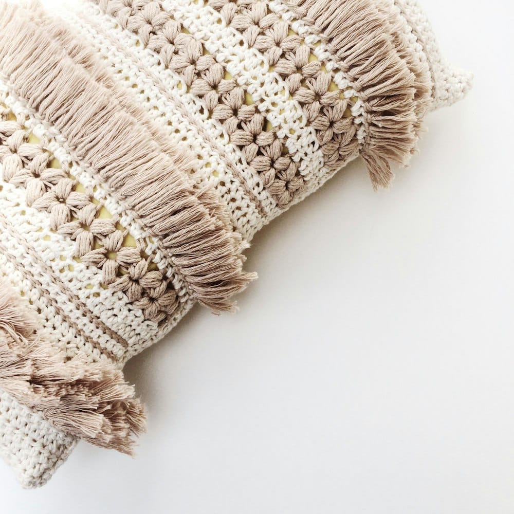 Close-up of a cream and taupe fringed crochet cushion